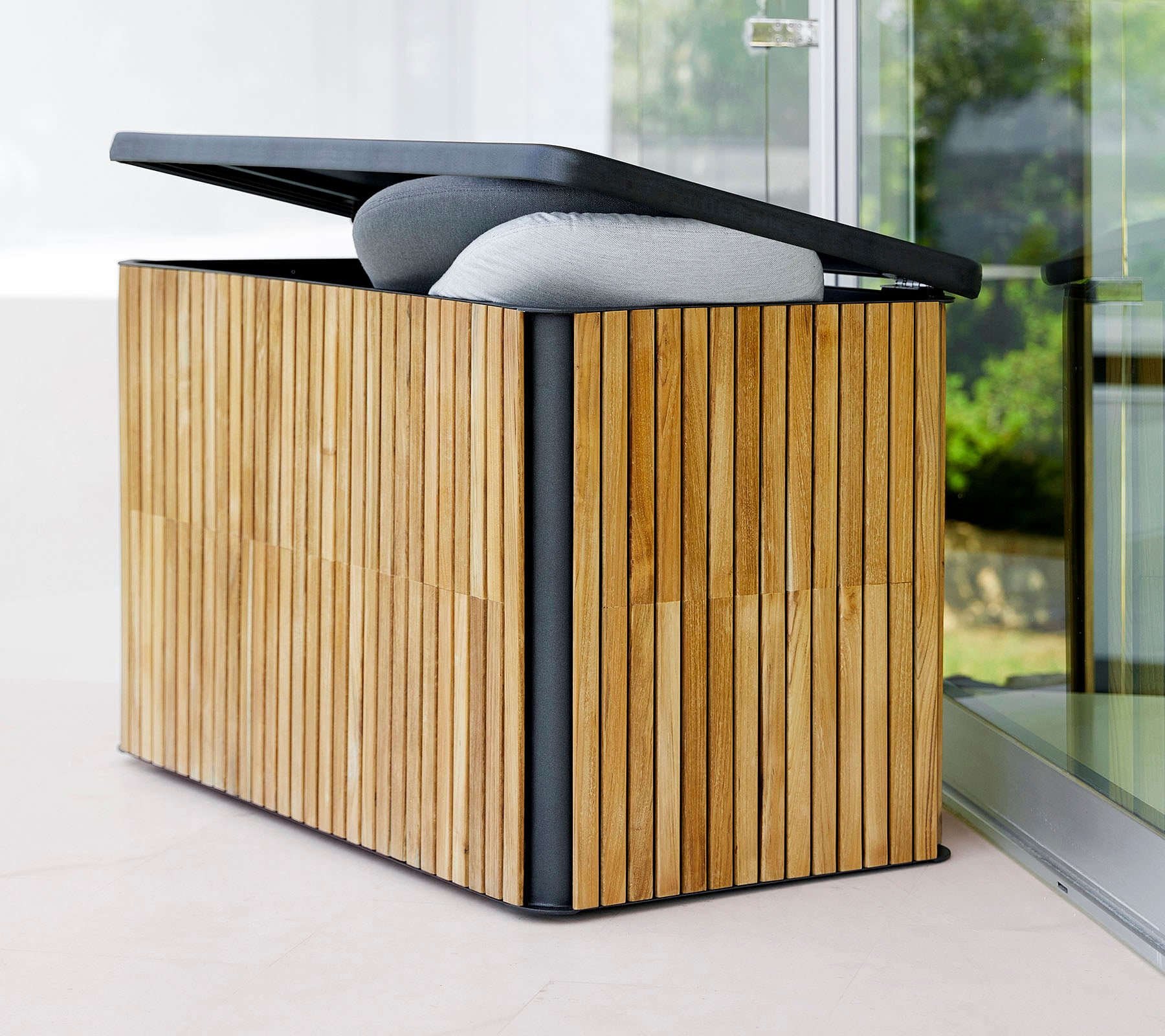Stylish storage box with a slatted wood exterior and a hinged lid, featuring a cushioned top for added comfort and functionality.