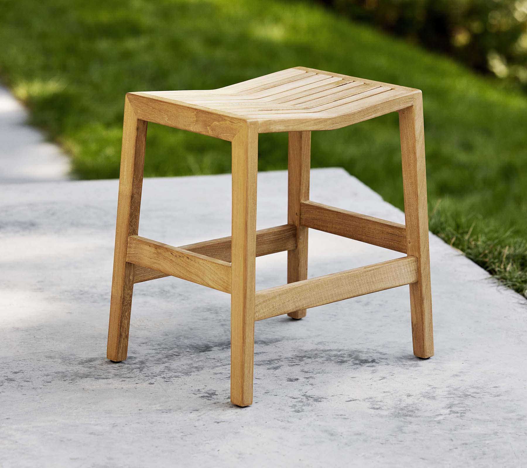 A wooden flip stool with a slatted seat and sturdy legs, designed for versatile seating or decorative use.